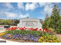 Cedar Township community sign surrounded by colorful tulip flower beds with a well-maintained landscape at 1393 Halpern Nw Ln, Kennesaw, GA 30144