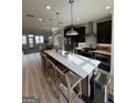 Open concept kitchen featuring an oversized island with barstool seating and stainless steel appliances at 1117 Larkin Dr, Buford, GA 30518