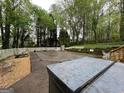 Spacious backyard with a covered pool and hot tub area, surrounded by lush trees at 525 Brooksdale Dr, Woodstock, GA 30189