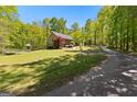 Beautiful ranch-style home featuring a long driveway and spacious, well-maintained front yard at 335 Winding Stream Trl, Hampton, GA 30228