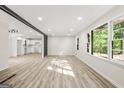 Spacious living room with lots of natural light, light wood floors, and an open concept design at 172 W Campbellton St, Fairburn, GA 30213