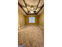 Cozy bedroom with trey ceiling, ceiling fan and large window at 4194 Wesley Hall Ln, Decatur, GA 30035