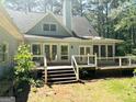 Backyard of house featuring a spacious deck and stairs at 100 Parliament Ct, Fayetteville, GA 30215