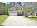 Traditional brick home featuring a spacious driveway, attached garage, and neatly landscaped front yard at 1619 Cascade Overlook, Peachtree City, GA 30269
