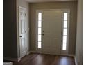 Bright foyer featuring hardwood floors and a front door with sidelights at 12214 Cypress Way, Fayetteville, GA 30215