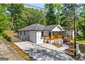 Beautifully renovated house with new concrete driveway, fresh exterior paint, and a inviting wood-railed front porch at 849 Wood Nw St, Atlanta, GA 30318