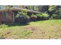 Spacious green backyard with some bushes and trees at 1198 Lynhurst Sw Dr, Atlanta, GA 30311