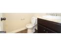 Cozy half bathroom features a modern vanity and toilet with stylish fixtures and neutral decor at 305 Wheeler Creek Ln # 21, Mcdonough, GA 30252