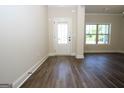 Bright foyer features attractive wood flooring, a white door, and natural light from a large window at 305 Wheeler Creek Ln # 21, Mcdonough, GA 30252