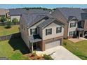 Aerial view of a two-story home featuring a well-maintained lawn and a brick-accented front at 1597 Culpepper Ln, Mcdonough, GA 30253