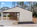 Spacious detached carport with lattice design and storage shed on a well-maintained lot at 111 Hamilton Rd, Peachtree City, GA 30269