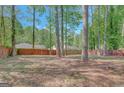 Large, fenced backyard with mature trees, offering privacy and plenty of space at 103 Bluegrass Trce, Peachtree City, GA 30269