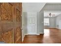 Entryway showcasing hardwood floors and an ornate carved wood front door at 103 Bluegrass Trce, Peachtree City, GA 30269