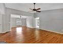 Spacious living room with hardwood floors, ceiling fan, and plenty of natural light at 103 Bluegrass Trce, Peachtree City, GA 30269