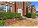 Close-up of front entrance with mulched flower beds and well manicured green bushes at 3971 Busby Mill Ct, Ellenwood, GA 30294