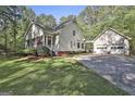 Well-maintained home with two-car garage, attached covered passage, and mature landscaping at 160 Wills Way, Fayetteville, GA 30214