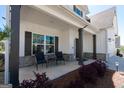 Covered front porch with stone accents and seating, perfect for relaxing outdoors at 44 Mediterranean Ave, Sharpsburg, GA 30277