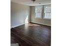 Bright bedroom featuring hardwood floors and natural light from the windows at 5949 Tyree Rd, Winston, GA 30187