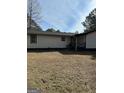 The side of the home is white with black trim and a small back porch at 5949 Tyree Rd, Winston, GA 30187
