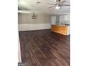 Open-concept living space with wood floors and a kitchen island at 5949 Tyree Rd, Winston, GA 30187