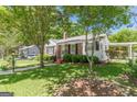 Charming brick home featuring a well-maintained lawn, mature trees, and classic black shutters at 1325 E Forrest Ave, East Point, GA 30344