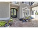 Elegant entryway with a double door, stone patio, and beautifully arranged flower pots for a welcoming appeal at 1105 Astoria Ln, Peachtree City, GA 30269