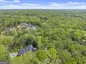 An aerial view of several large homes surrounded by lush, mature trees at 3985 Randall Mill Nw Rd, Atlanta, GA 30327