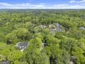 An aerial view of several large homes surrounded by lush, mature trees at 3985 Randall Mill Nw Rd, Atlanta, GA 30327