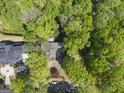 Aerial view of a charming house nestled among lush trees and a circular driveway at 3985 Randall Mill Nw Rd, Atlanta, GA 30327