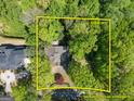 Aerial view shows property lines of /- 0.99 acres surrounded by lush greenery and mature trees at 3985 Randall Mill Nw Rd, Atlanta, GA 30327