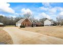 Sprawling home with a long driveway and ample parking space, surrounded by a lush yard at 115 Stewart Hollow Ln, Covington, GA 30016
