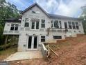 The new construction home featuring a walkout basement and large windows at 2012 Lakeview Pkwy, Villa Rica, GA 30180