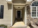 Inviting front entrance with stone accents, a decorated door, and tasteful landscaping at 992 Cove Lake Ct, Lawrenceville, GA 30045