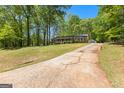 Sprawling single-story home with an extended driveway and lush landscaping, plus additional detached garage at 370 Merrydale Dr, Fayetteville, GA 30215