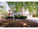 Charming two-story home with brick and siding, a blue front door, and well-manicured landscaping at 1417 Se Pickett'S Ct, Conyers, GA 30013