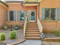 Charming home's front entrance features brick steps, a welcoming wreath, and decorative accents at 318 Dogwood Trce, Mcdonough, GA 30252