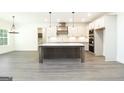 Gourmet kitchen featuring a large island, stainless steel appliances, and custom cabinetry at 2109 Ella Springs Dr, Covington, GA 30014