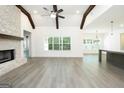 Spacious living room featuring beamed ceilings, fireplace, and ample natural light at 2109 Ella Springs Dr, Covington, GA 30014