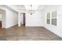 Elegant dining room with wood floors, decorative molding, modern chandelier, and lots of natural light at 2117 Ella Springs Dr, Covington, GA 30014
