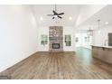 Spacious living room featuring wood flooring, a brick fireplace, and plenty of natural light at 2117 Ella Springs Dr, Covington, GA 30014