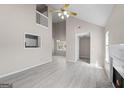 Bright living room with soaring ceilings, fireplace, and expansive floors at 5882 Trent Walk Dr, Lithonia, GA 30038
