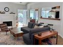 Bright living room with a cozy fireplace, modern furnishings, and access to outdoor spaces at 403 Rock Creek Dr, Peachtree City, GA 30269
