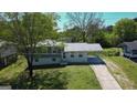 Aerial view of a charming two-story home with a covered carport and well-manicured lawn and mature trees at 2571 Stanford Dr, Ellenwood, GA 30294