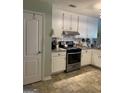 Neutral color kitchen featuring white cabinets, tile backsplash and stainless steel appliances at 187 Pine Branch Dr, Stockbridge, GA 30281