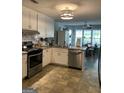 Well-lit kitchen featuring white cabinetry, stainless steel appliances, and view into breakfast nook at 187 Pine Branch Dr, Stockbridge, GA 30281