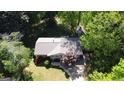 Aerial view of a well-maintained single story home surrounded by lush greenery and mature trees at 2836 Belaire Cir, Doraville, GA 30340