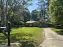 View of the home from the street, featuring a well-manicured lawn and a mailbox with the address at 2836 Belaire Cir, Doraville, GA 30340