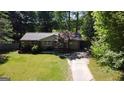 Charming single story brick home featuring a well-manicured lawn and a mature tree in the front yard at 2836 Belaire Cir, Doraville, GA 30340