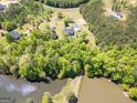 Picturesque aerial view of the wooded property, including a private pond at 637 Lakeview Dr, Newborn, GA 30056