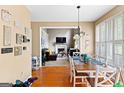 Open dining area with hardwood floors that flows seamlessly into the living room at 122 Ardenlee Dr, Peachtree City, GA 30269